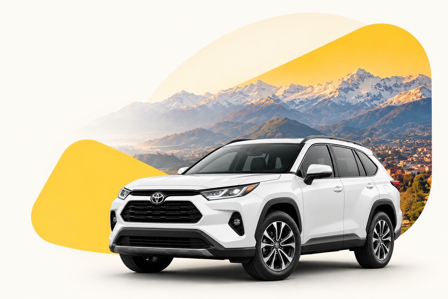 White SUV in front of snow-capped mountains
